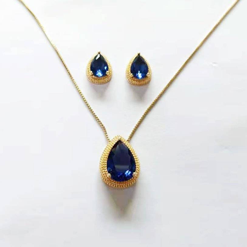 a necklace and earring set with blue stones