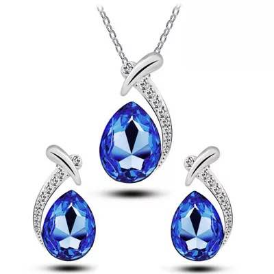 three pieces of jewelry set with blue crystal stones