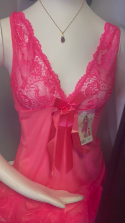 a mannequin wearing a pink dress and a necklace