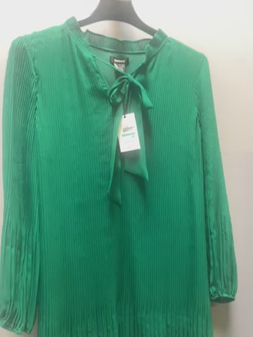 a green blouse with a bow at the neck