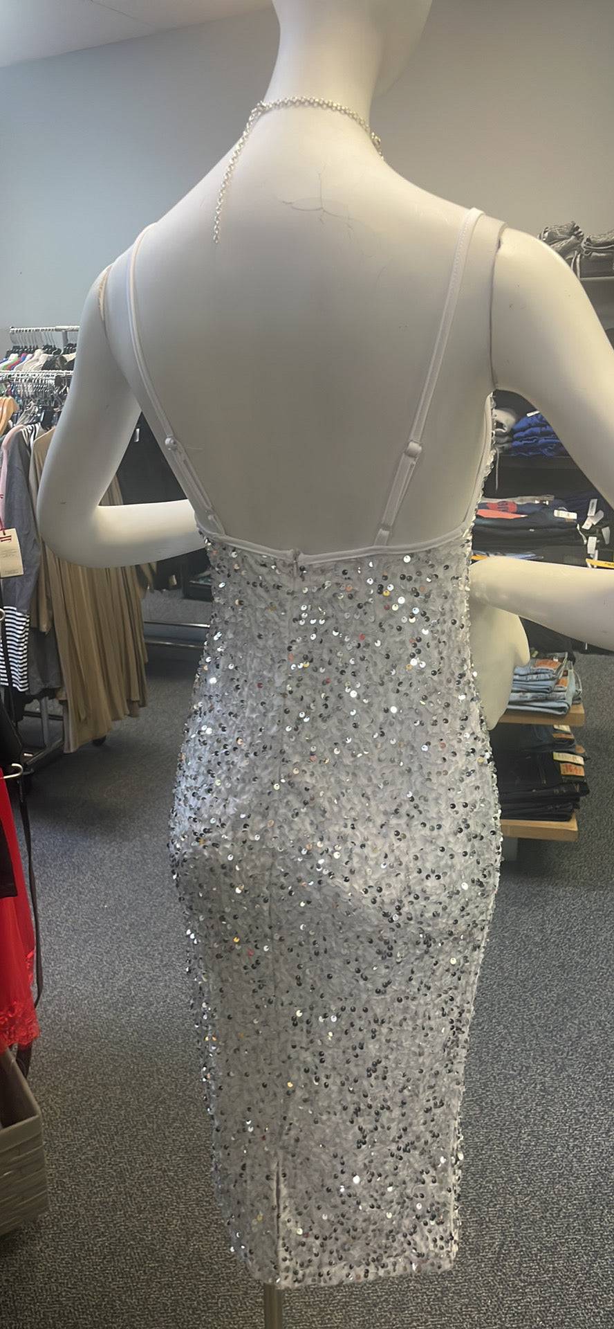 a mannequin wearing a dress made of silver sequins