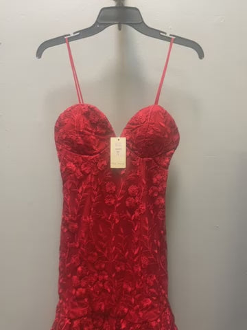 a red dress hanging on a hanger